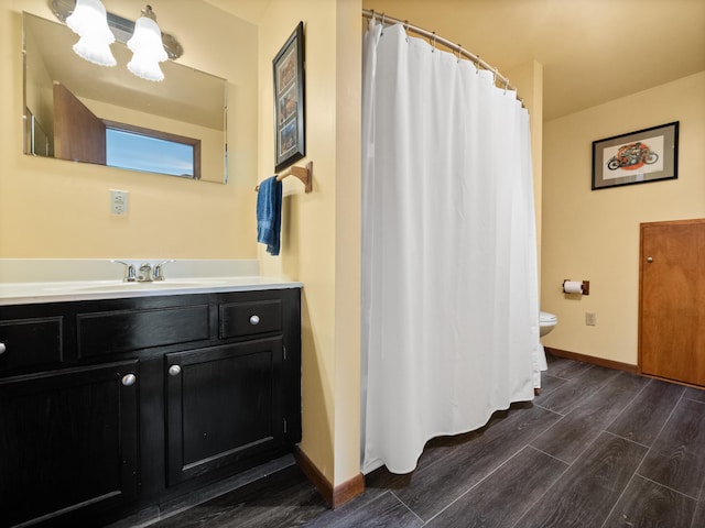 17170 Highview Ave, Minnewaska Twp, MN 56334 - bathroom featuring toilet, vanity, wood finished floors, a chandelier, and baseboards