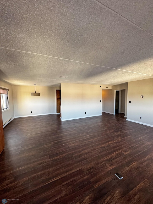 1110 3rd Ave N Unit 704E, Fargo, ND 58102 - unfurnished living room featuring a baseboard heating unit, dark wood finished floors, baseboards, and a textured ceiling