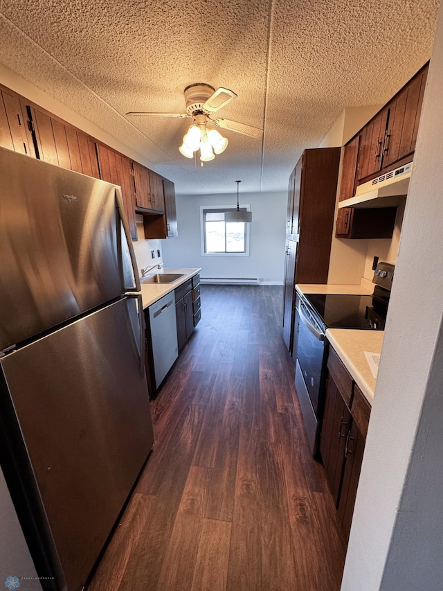 1110 3rd Ave N Unit 704E, Fargo, ND 58102 - kitchen featuring dark wood finished floors, ceiling fan, light countertops, under cabinet range hood, and appliances with stainless steel finishes