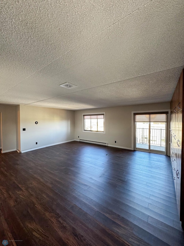 1110 3rd Ave N Unit 704E, Fargo, ND 58102 - empty room featuring baseboard heating, dark wood finished floors, baseboards, and a textured ceiling
