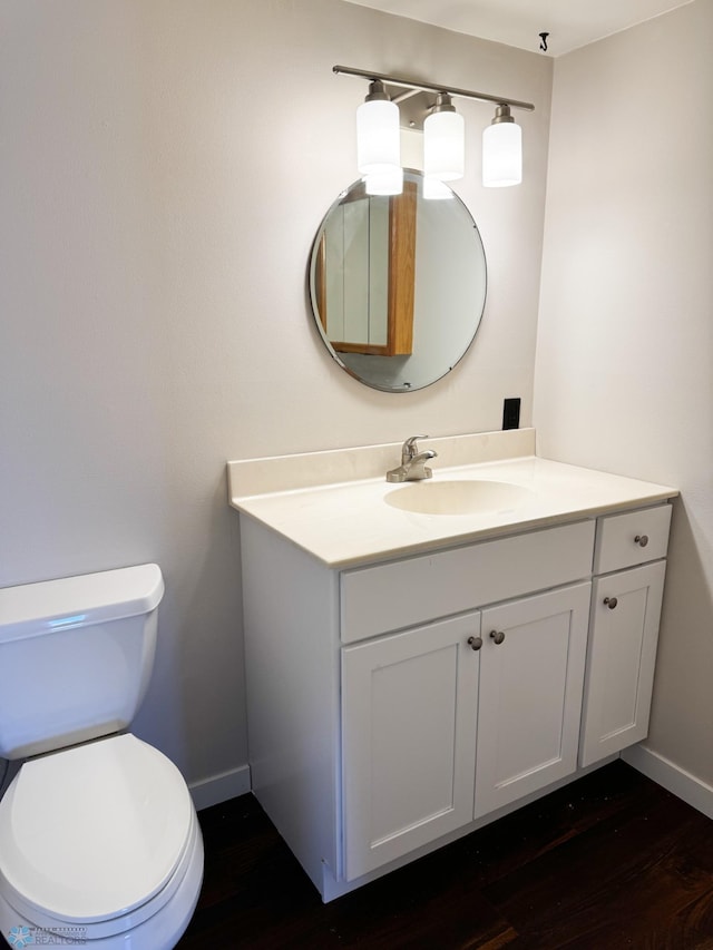 1110 3rd Ave N Unit 704E, Fargo, ND 58102 - bathroom with wood finished floors, vanity, toilet, and baseboards