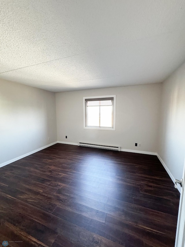 1110 3rd Ave N Unit 704E, Fargo, ND 58102 - spare room with baseboards, a textured ceiling, a baseboard radiator, and dark wood-style flooring