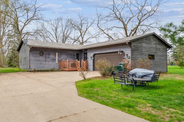 view of front facade with an attached garage, a front yard, and concrete driveway