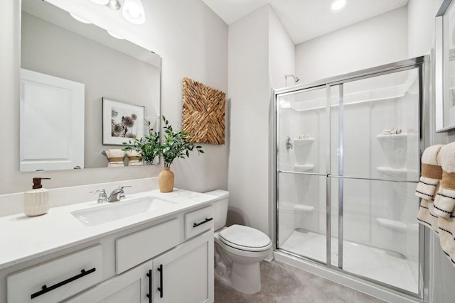 full bath featuring toilet, a shower stall, and vanity