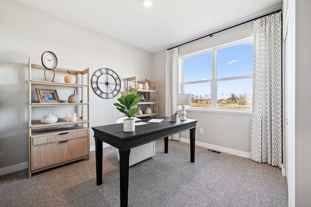 carpeted home office featuring visible vents, vaulted ceiling, and baseboards