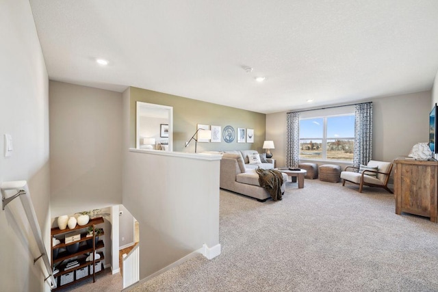 living area with recessed lighting, carpet flooring, and baseboards