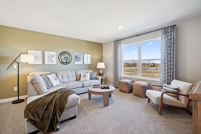 living room with a textured ceiling, carpet, and baseboards