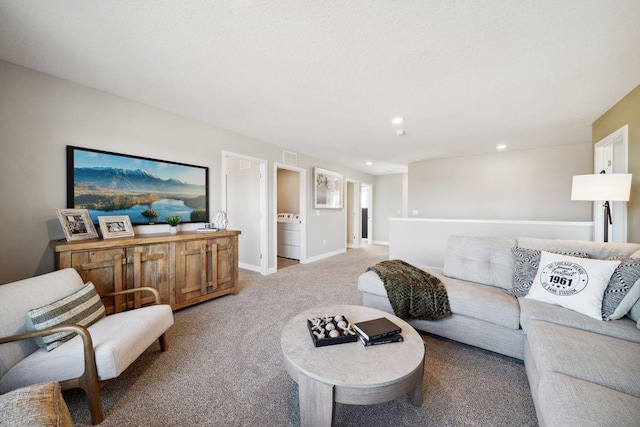 living area featuring recessed lighting, washer / clothes dryer, visible vents, light carpet, and baseboards