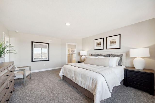 carpeted bedroom featuring connected bathroom, visible vents, and baseboards