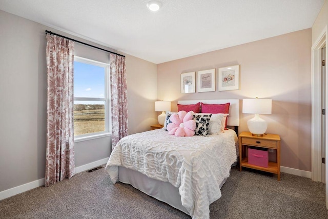 carpeted bedroom with visible vents and baseboards