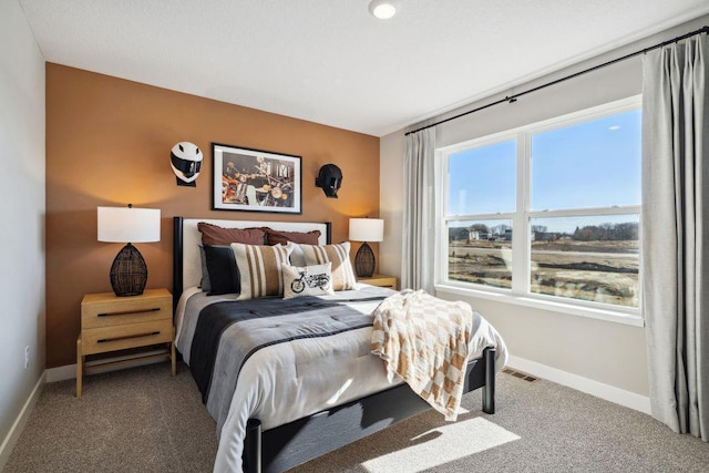 carpeted bedroom with visible vents and baseboards