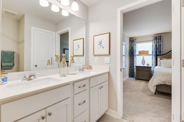 full bath featuring double vanity, visible vents, a sink, and ensuite bathroom