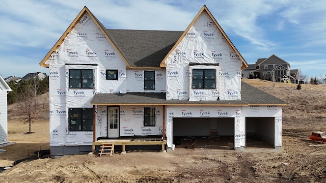 property under construction with a shingled roof