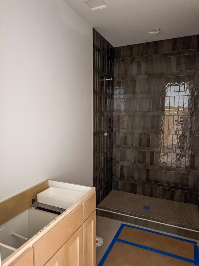 bathroom with tiled shower