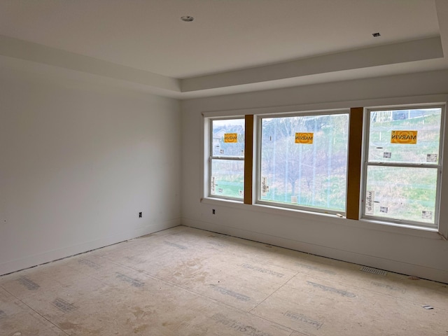 spare room with plenty of natural light, baseboards, and visible vents