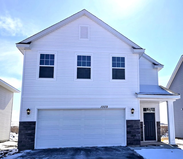 view of front facade with stone siding and an attached garage