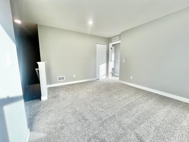 spare room with visible vents, baseboards, and carpet flooring