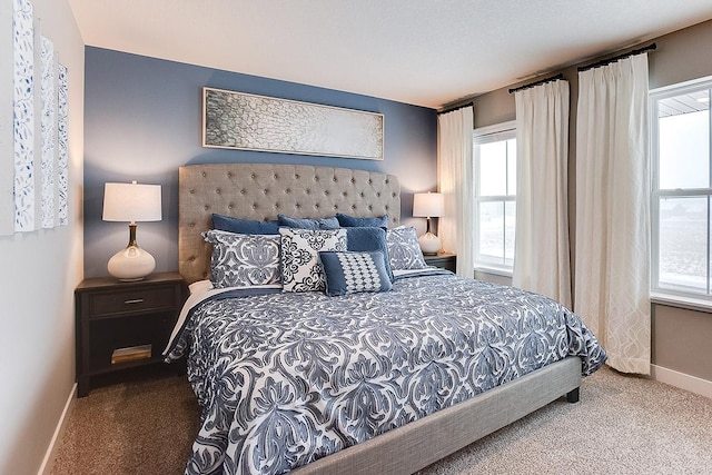 carpeted bedroom featuring baseboards