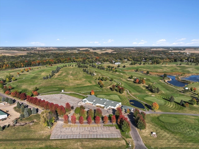 drone / aerial view with golf course view and a water view