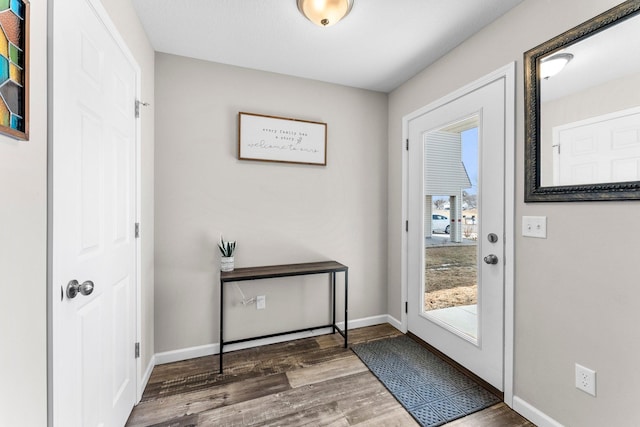 entryway with baseboards and wood finished floors