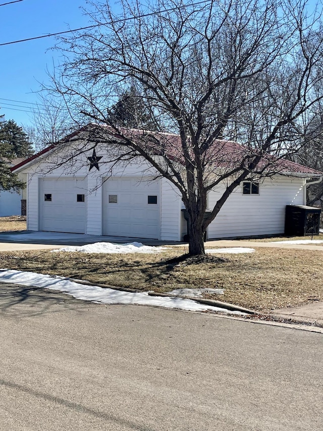 view of property exterior with a garage and an outbuilding