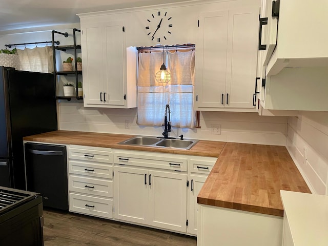 kitchen featuring a sink, black appliances, wood counters, and white cabinets