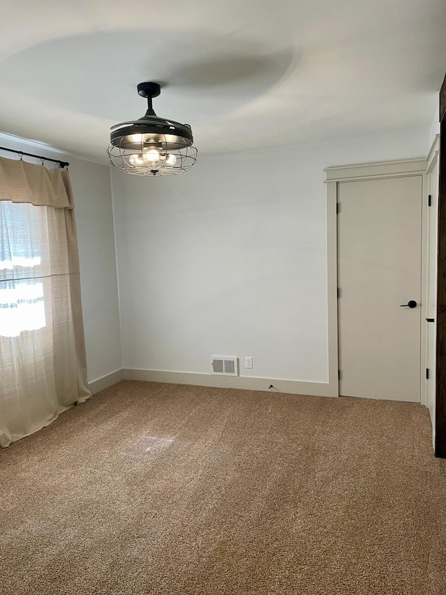 unfurnished room featuring carpet floors and visible vents