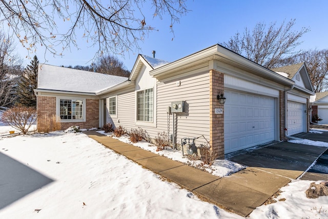 view of front of house featuring a garage and brick siding