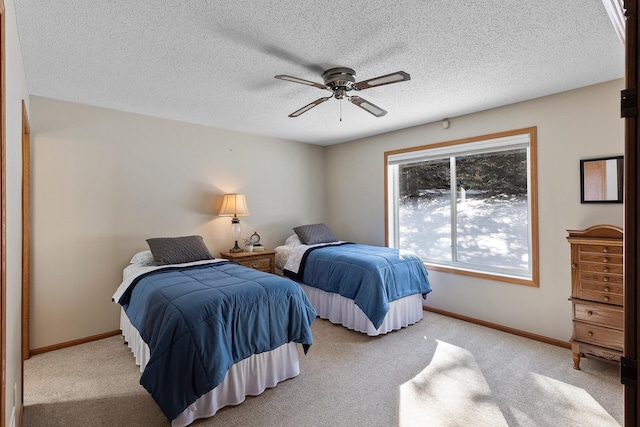 bedroom featuring baseboards, light colored carpet, and a ceiling fan