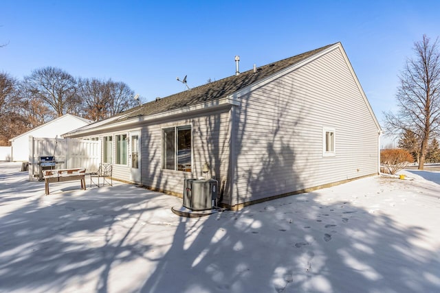 rear view of property featuring cooling unit, fence, and a patio area