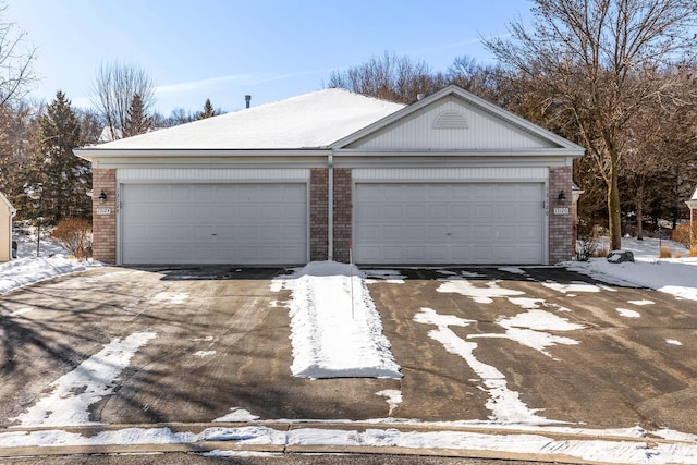 view of front of property with brick siding, an outbuilding, and a garage