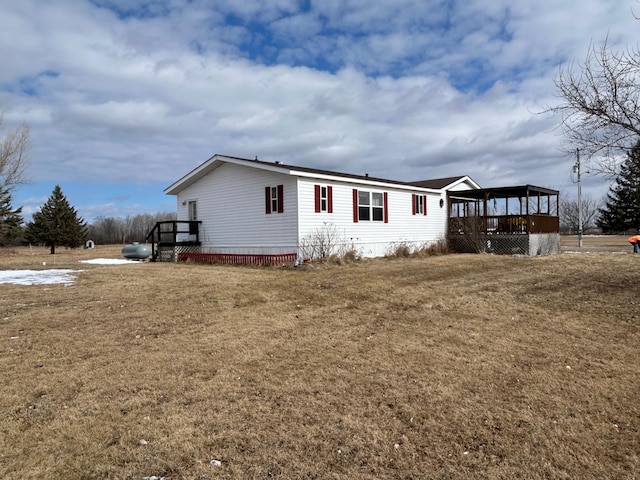 view of front of house with a front lawn and a sunroom