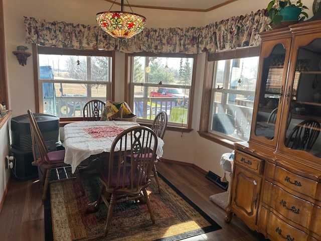 dining space with baseboards and dark wood-style flooring