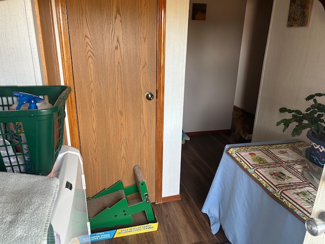 interior space with baseboards and wood finished floors