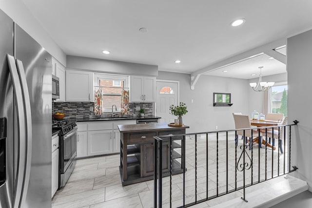 607 Adams St NE, Minneapolis, MN 55413 - kitchen with appliances with stainless steel finishes, dark countertops, tasteful backsplash, a sink, and recessed lighting