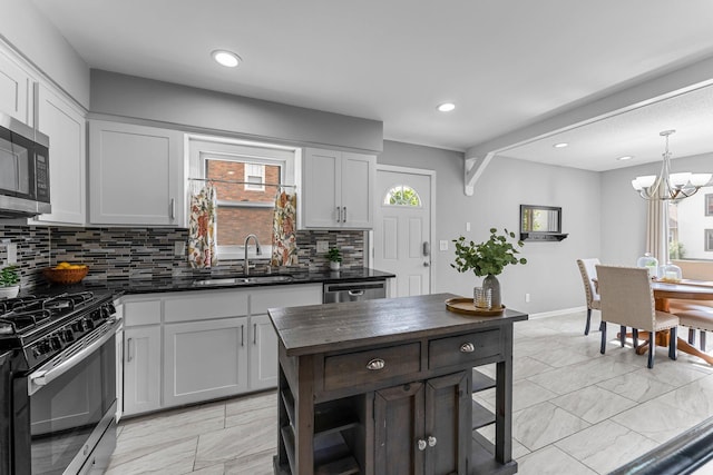 607 Adams St NE, Minneapolis, MN 55413 - kitchen featuring a sink, stainless steel appliances, backsplash, a chandelier, and wood counters