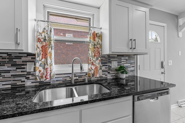607 Adams St NE, Minneapolis, MN 55413 - kitchen featuring dishwasher, a sink, dark stone counters, decorative backsplash, and white cabinetry