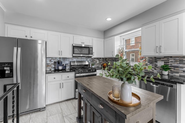 607 Adams St NE, Minneapolis, MN 55413 - kitchen with stainless steel appliances, white cabinetry, decorative backsplash, and recessed lighting