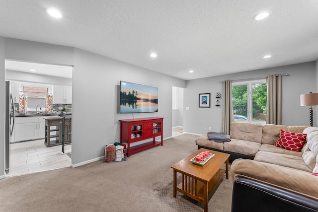 607 Adams St NE, Minneapolis, MN 55413 - living area featuring recessed lighting, light colored carpet, baseboards, and a textured ceiling