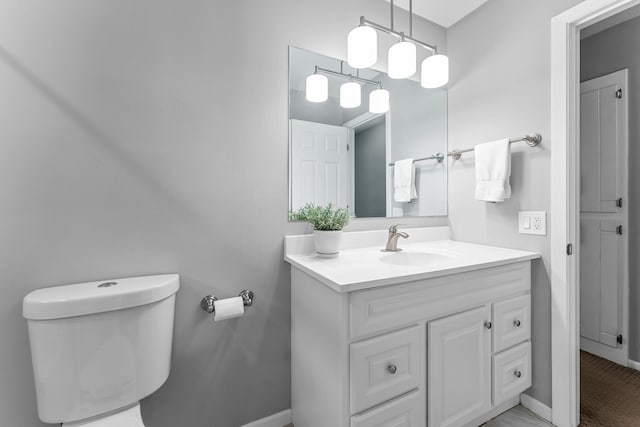607 Adams St NE, Minneapolis, MN 55413 - bathroom with toilet, vanity, and baseboards