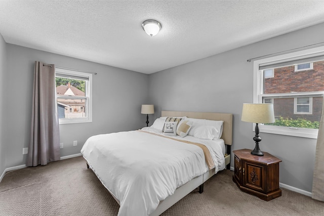 607 Adams St NE, Minneapolis, MN 55413 - carpeted bedroom featuring baseboards and a textured ceiling