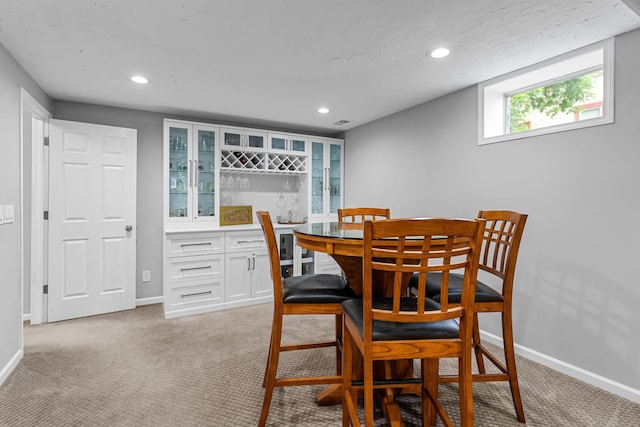 607 Adams St NE, Minneapolis, MN 55413 - dining room featuring recessed lighting, baseboards, light colored carpet, and bar area