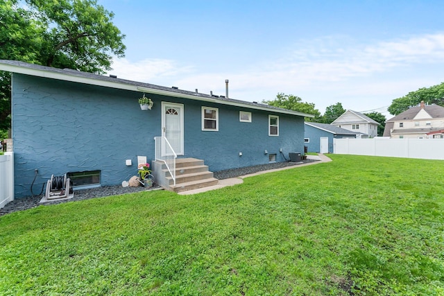 607 Adams St NE, Minneapolis, MN 55413 - rear view of property with stucco siding and entry steps