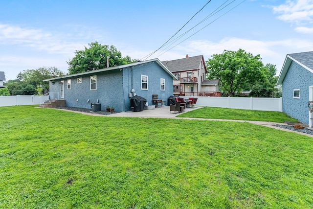 607 Adams St NE, Minneapolis, MN 55413 - back of house with a patio, central AC, and stucco siding