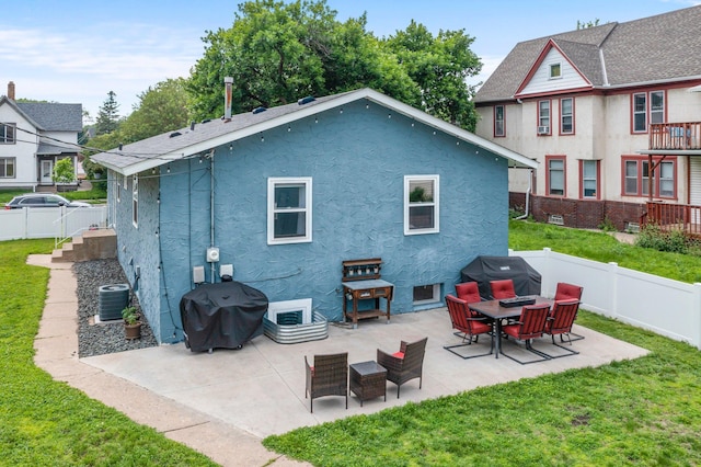 607 Adams St NE, Minneapolis, MN 55413 - rear view of property with stucco siding, a patio area, and central air condition unit