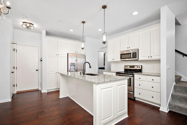 kitchen featuring a sink, dark wood-type flooring, appliances with stainless steel finishes, white cabinetry, and backsplash