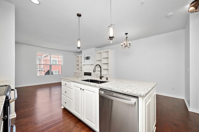 kitchen with a sink, open floor plan, dark wood finished floors, appliances with stainless steel finishes, and baseboards