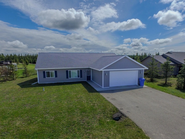 ranch-style home with aphalt driveway, a front yard, and an attached garage