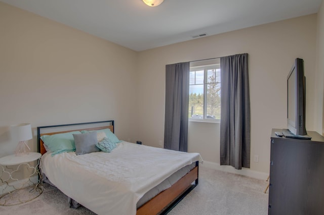 carpeted bedroom featuring visible vents and baseboards