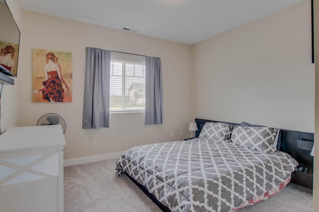 carpeted bedroom with visible vents and baseboards